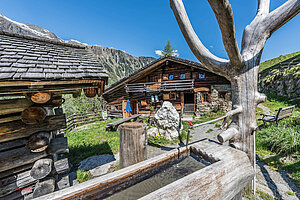 Hütten-Tipp der Woche Urige Almhütte mit Brunnen und liebevoll dekoriertem Garten.